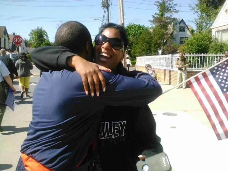 two people that are hugging while wearing sunglasses