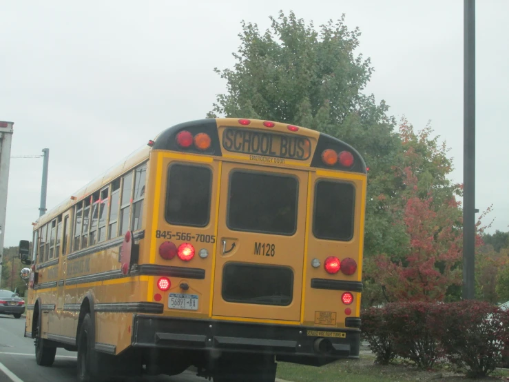 a school bus moving along the road through traffic