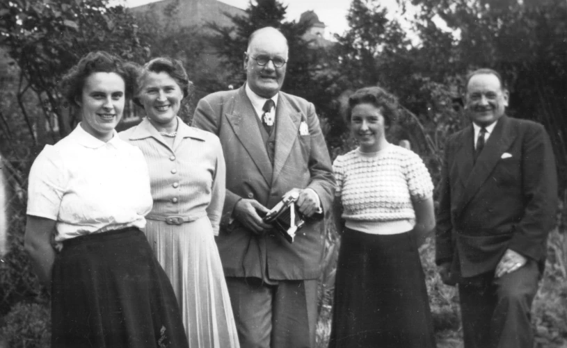 an old black and white po shows people in formal wear