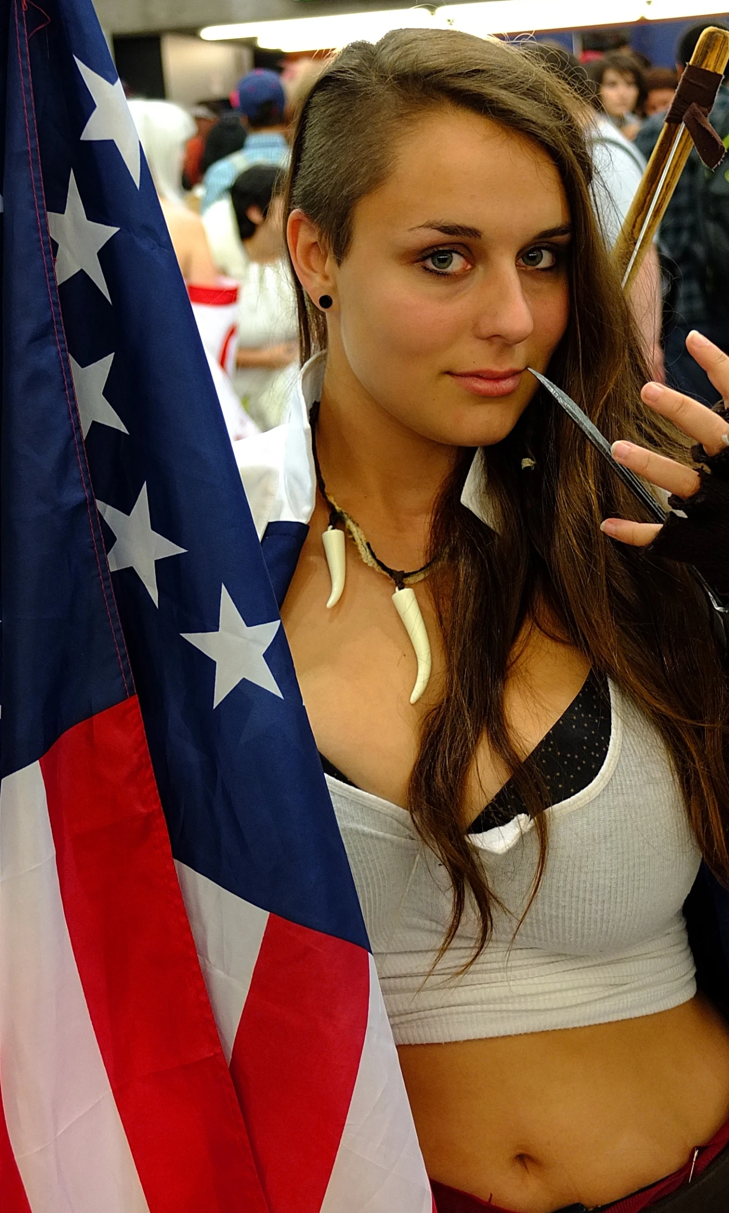 a woman holding an umbrella next to a flag