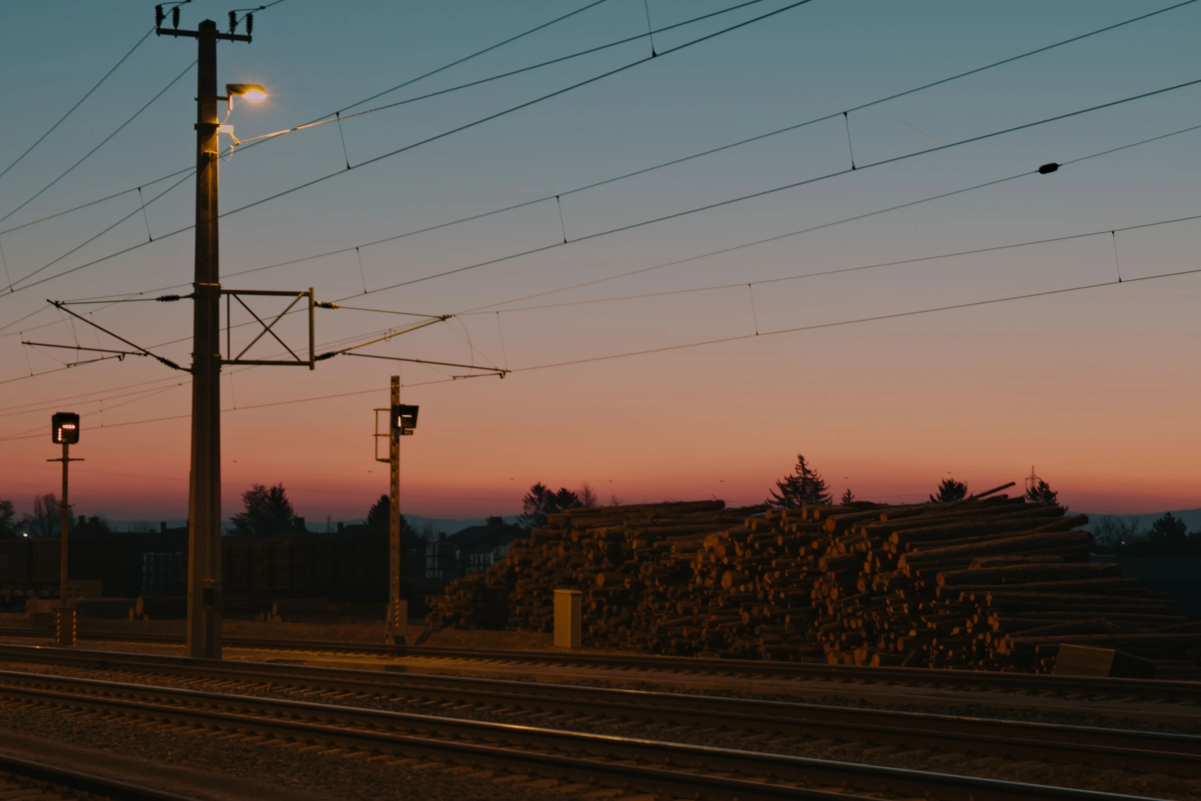 a railroad track that has some electrical wires above it