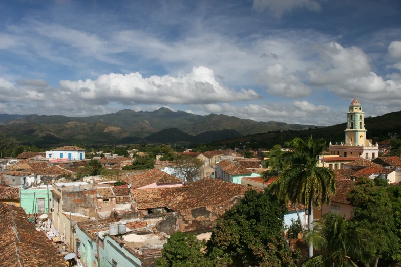 a bird eye view of the city in front of mountains