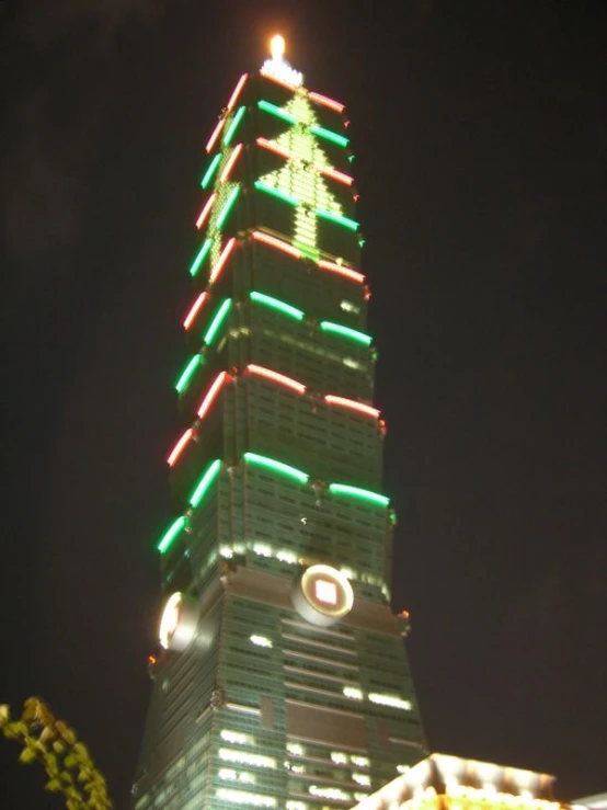 a tall clock tower with lights all around it