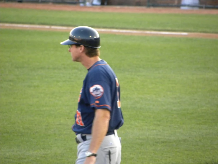 baseball player in uniform walking around on the field