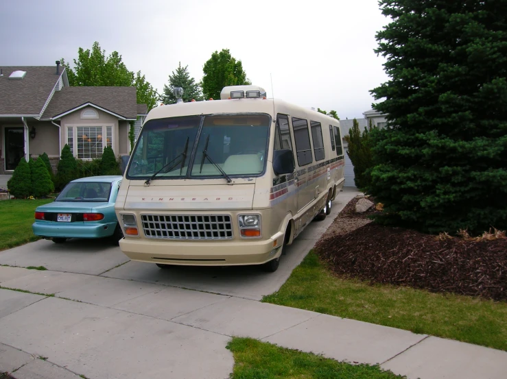 a rv is parked next to another vehicle on the side of the road