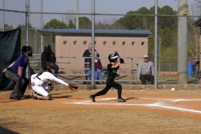 a baseball player is swinging at a ball