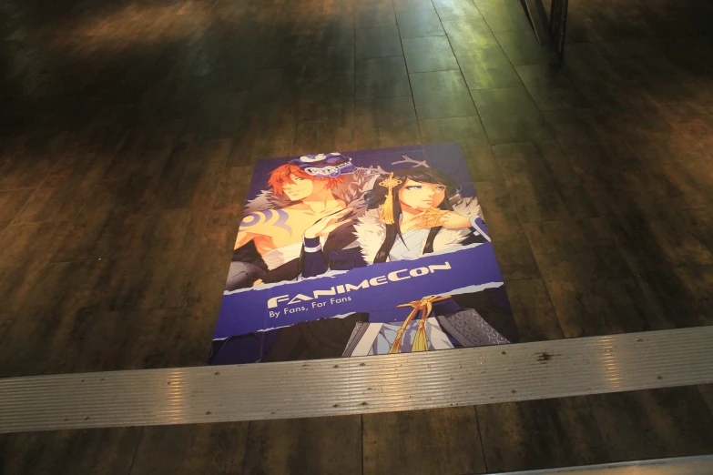 the poster has people on it that is on a floor