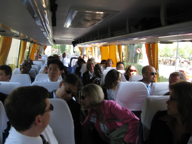 people sit on a bus, in between seats