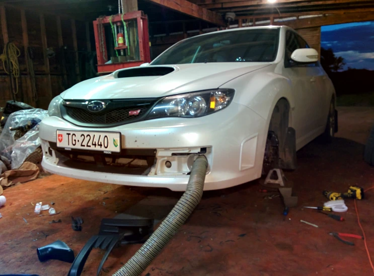 a white car is parked in a garage