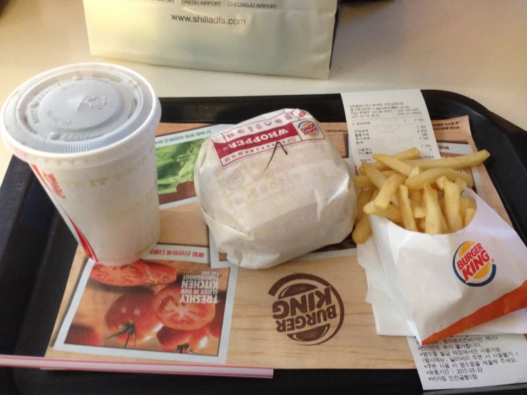 a tray of food with fries and drink