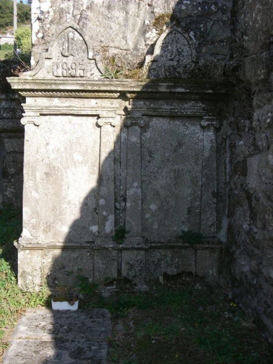 a couple of old tombstones sitting next to each other