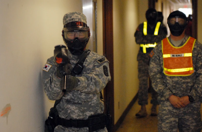 soldiers wearing safety gear in a hallway