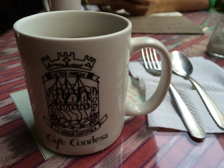 a close up of a coffee mug and spoon
