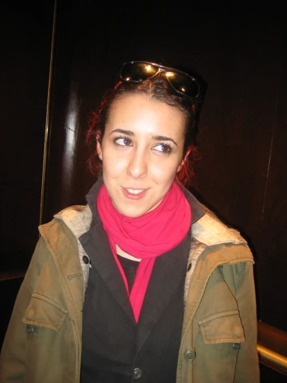 a woman wearing sunglasses and a red scarf