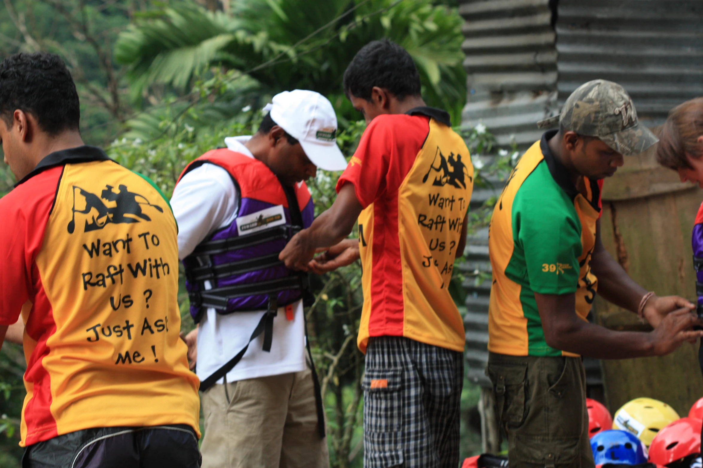 group of men in colorful vests checking out items