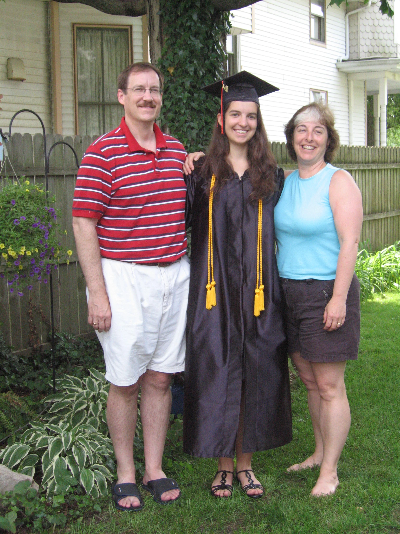 a couple of people in graduation gown standing next to each other