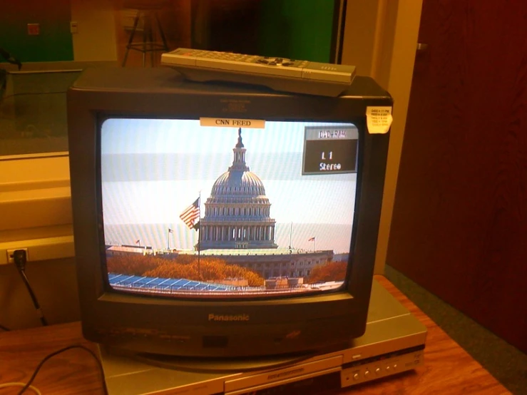 a television is on and the picture of capitol