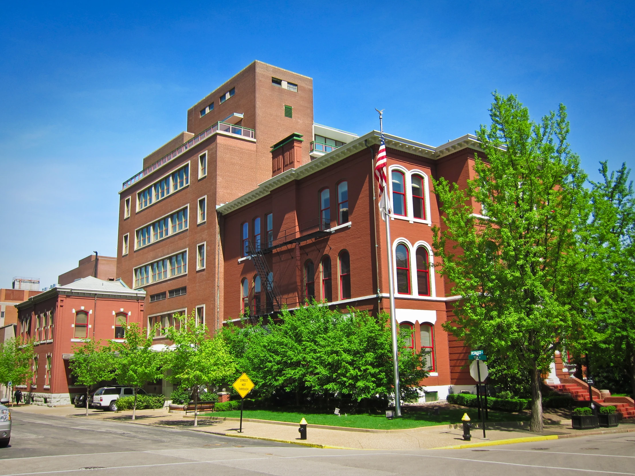 a tall building with many windows on the front and corner of it