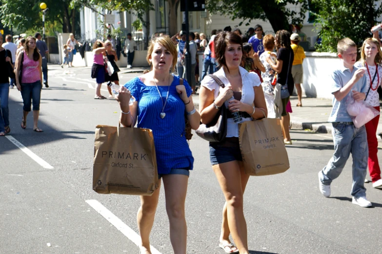 people are walking around the town together with bags