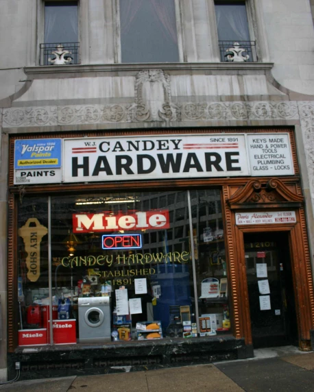 a display of items inside the front windows of a hardware store