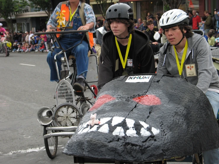 a couple of guys riding bikes next to a car