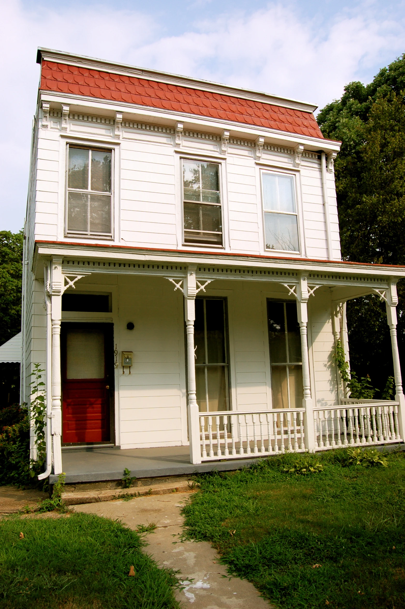 the house is white with red roof and black shutters