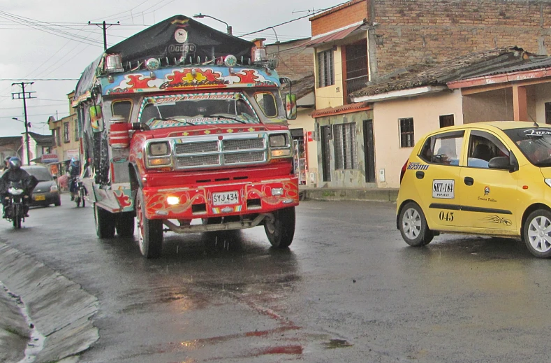 the red truck is next to the small yellow car