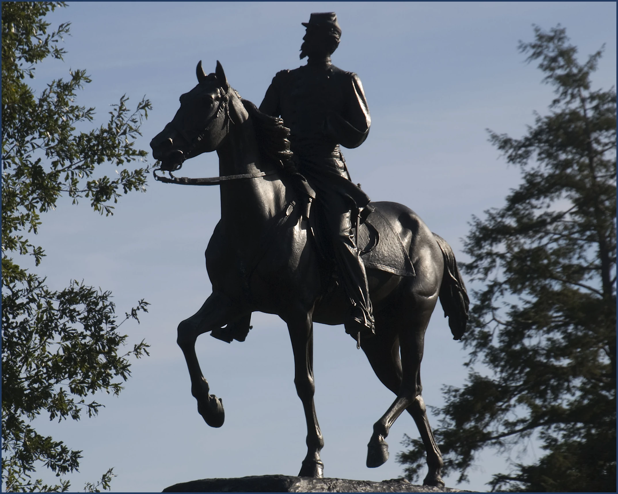 a statue of a man in uniform riding a horse