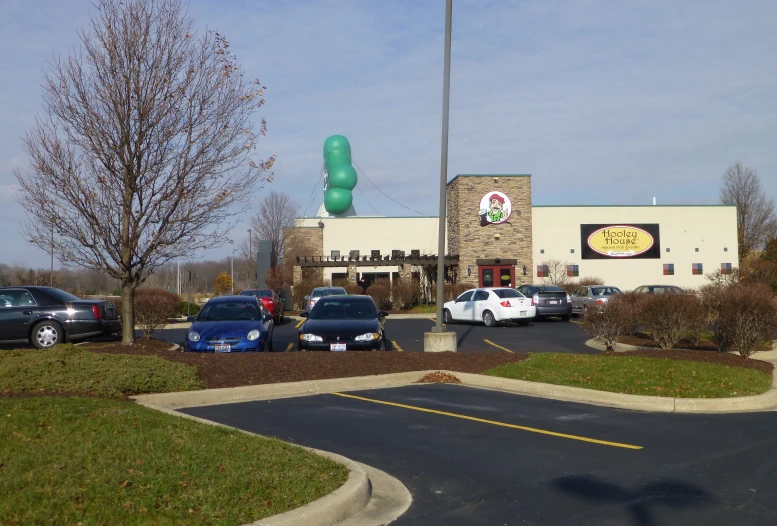 the exterior of a deli with cars parked out front