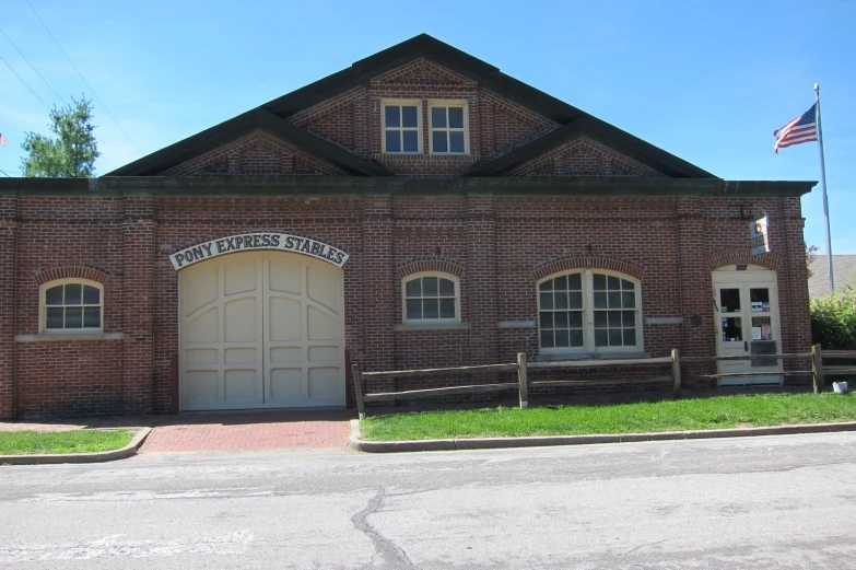 an old brick building with two large doors on the side