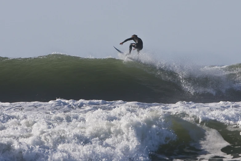 a person on a surfboard riding on a wave