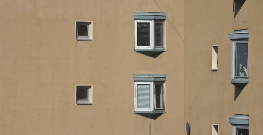 three windows on the side of a building
