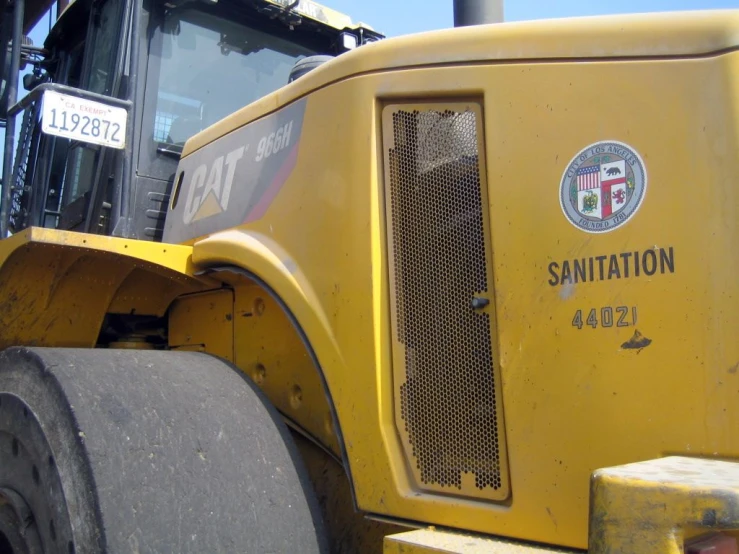 a close up image of the front of a yellow tractor