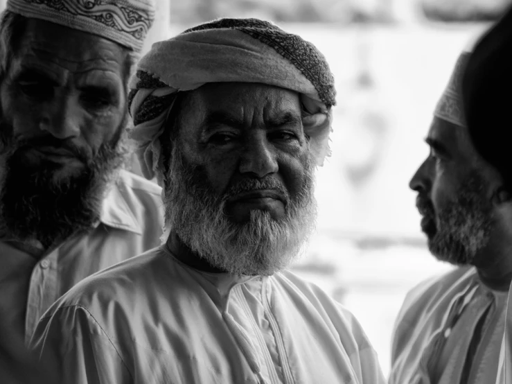 a group of four men who are standing together