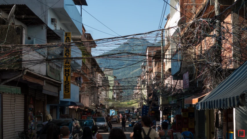 a street with buildings and wires above it