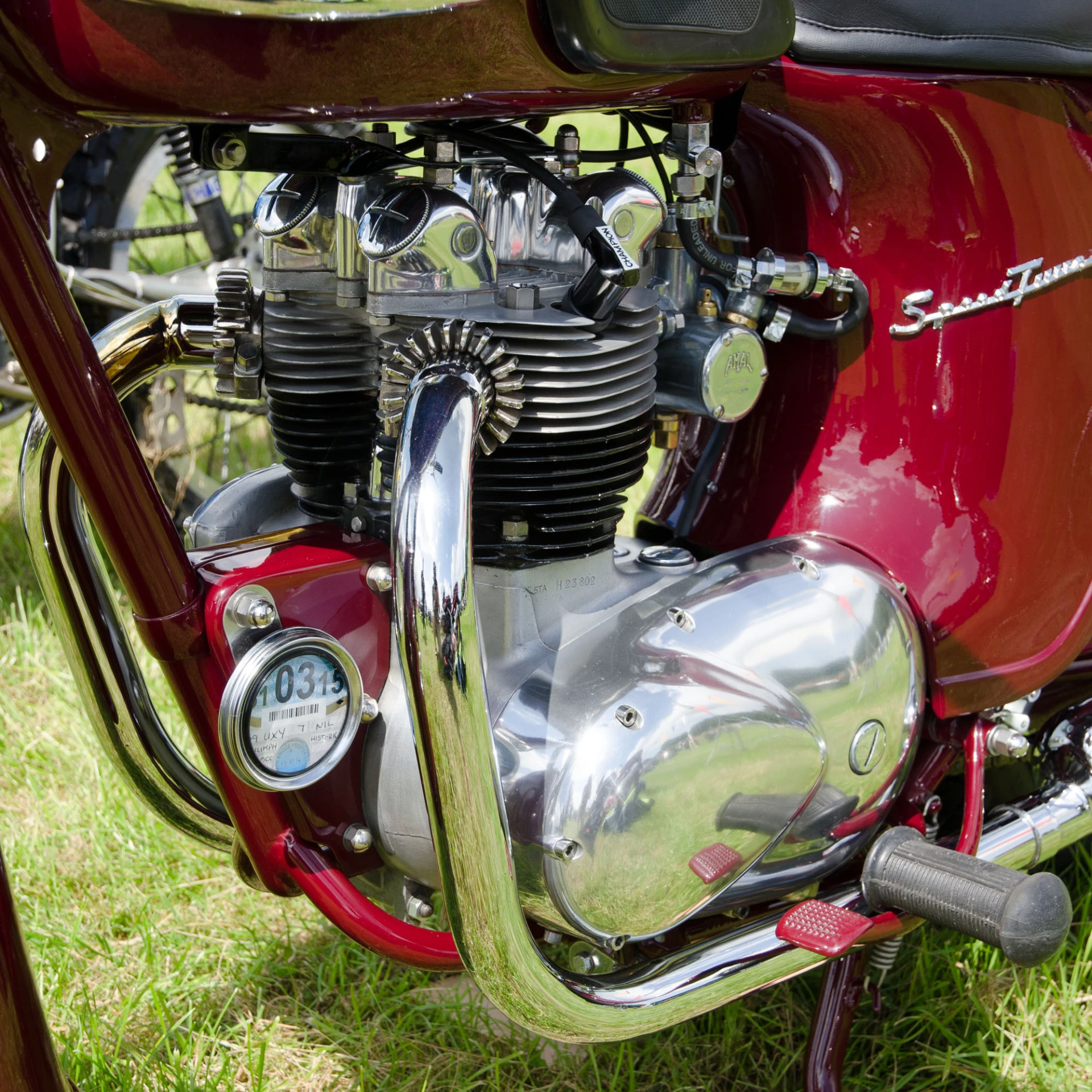 red bike with chrome trim parked on grass