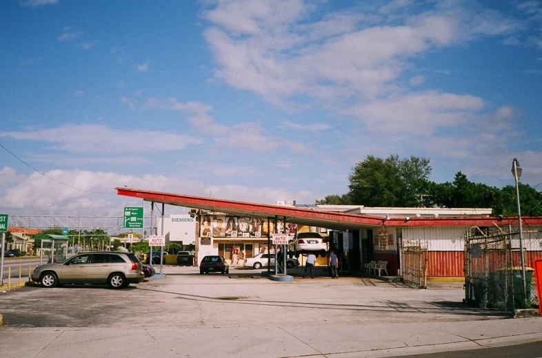 a car is parked in front of a gas station