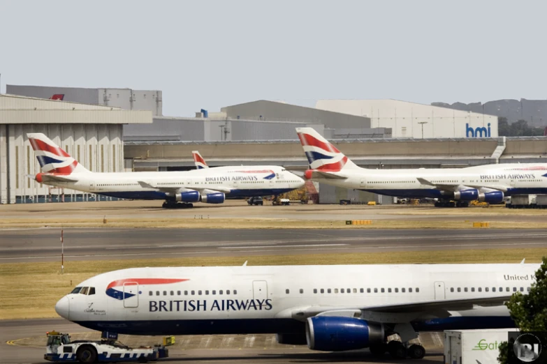 three british airways planes parked on the runway