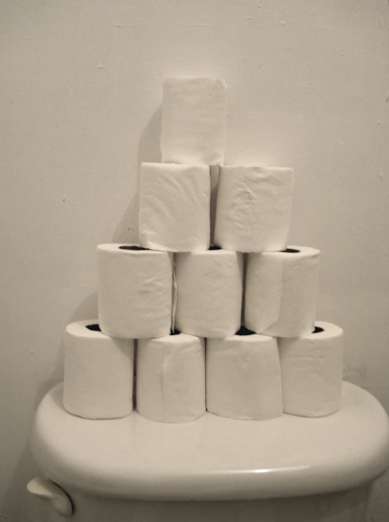 a white toilet covered in several rolls of toilet paper