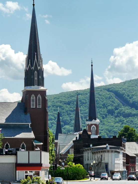 a town has steep spires and green hills