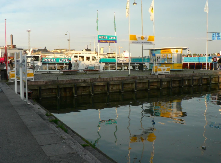 the trucks are parked beside the dock with water