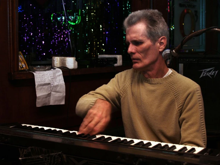 a man playing an organ in a living room