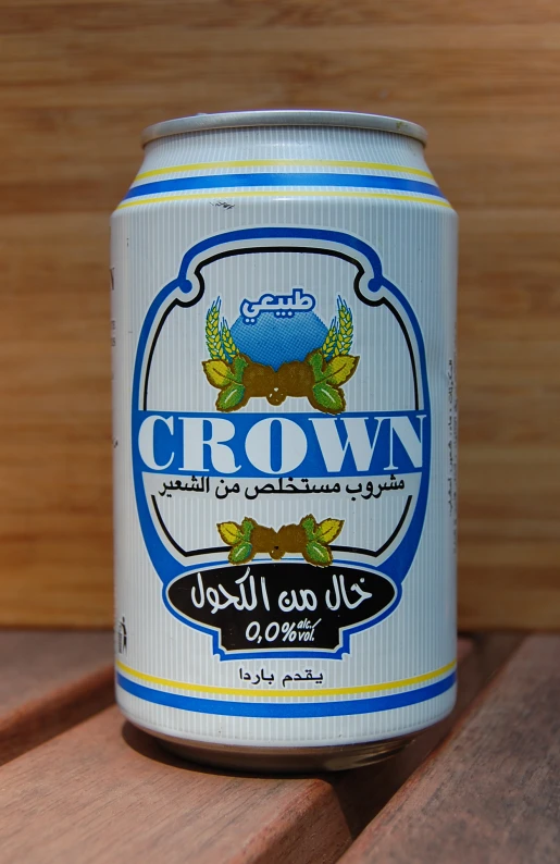 an old crown beer in a can sits on the table