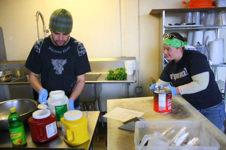 two people in a kitchen preparing food together