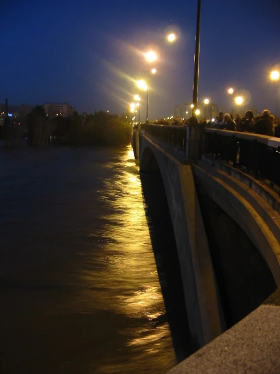 night scene of roadway lighting over water