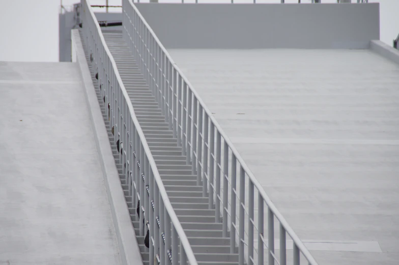 a stair railing with metal bars going down the side of it