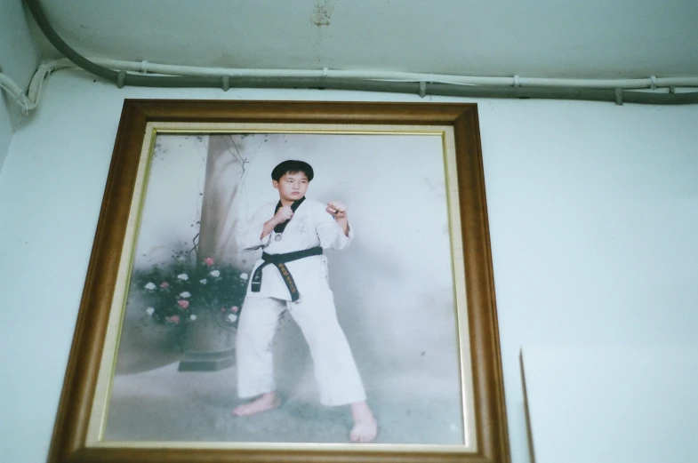 a framed pograph of a man wearing a karate uniform