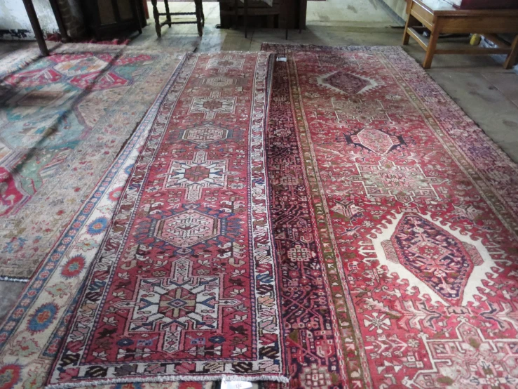 a red antique rug on the floor of an older house