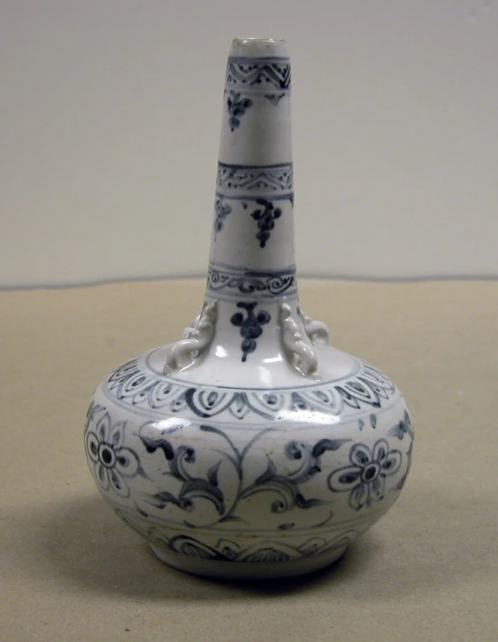 a very pretty blue and white vase on a table