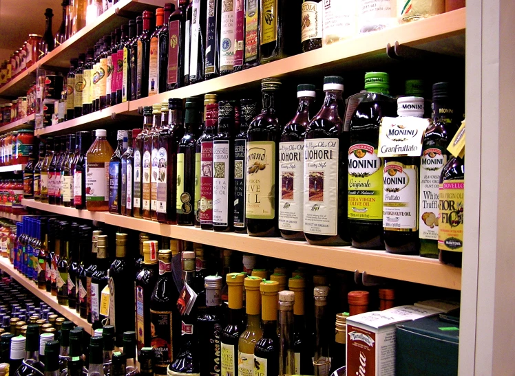 a wide variety of bottles sit on a shelf